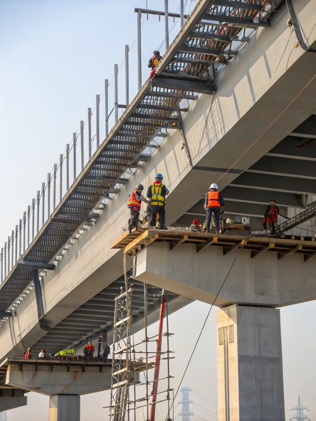 An image representing engineering achievements, featuring a modern bridge design, a sustainable building, and a robotic arm working on a complex project.